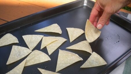 putting-tortilla-chips-on-pan-resized